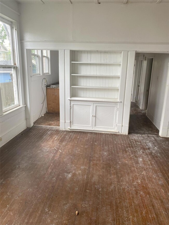 Unfurnished living room with dark wood-type floori