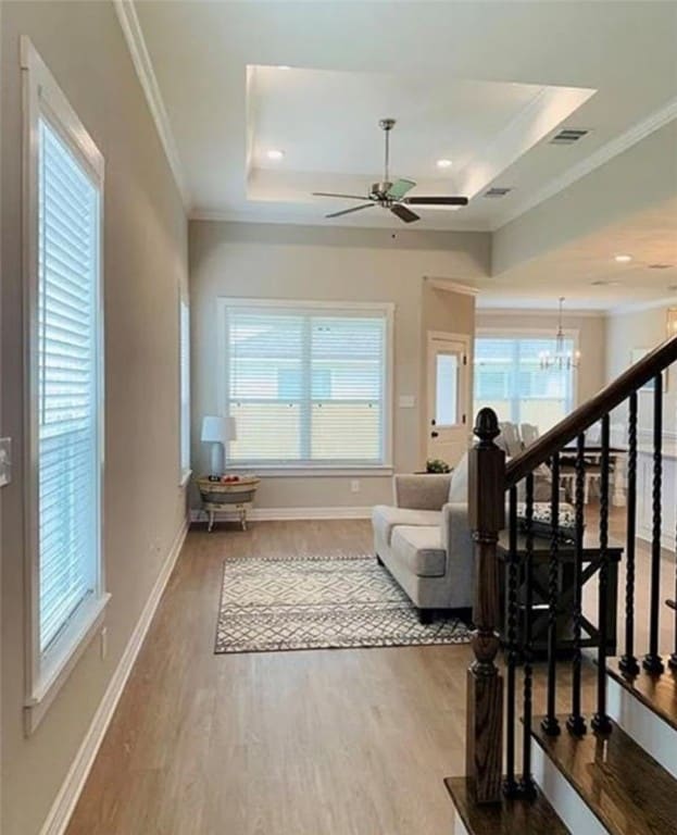 Living room with a tray ceiling, plenty of natural