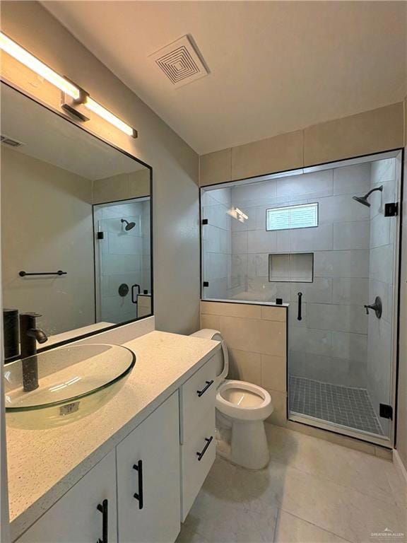 Full bath featuring a stall shower and vanity