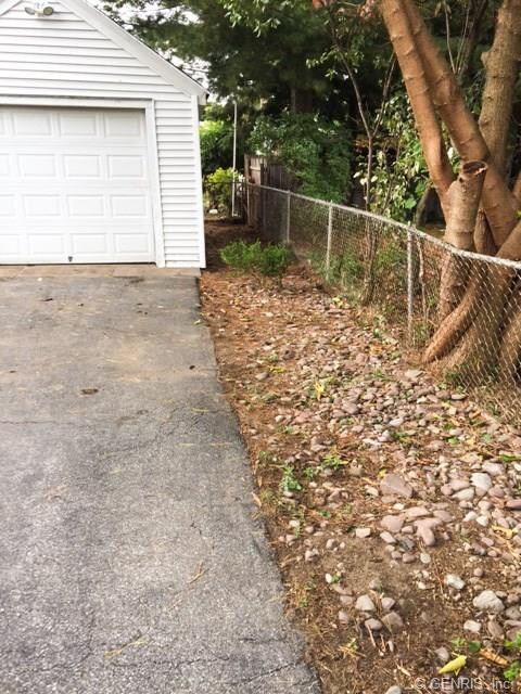 Side of driveway in front of garage