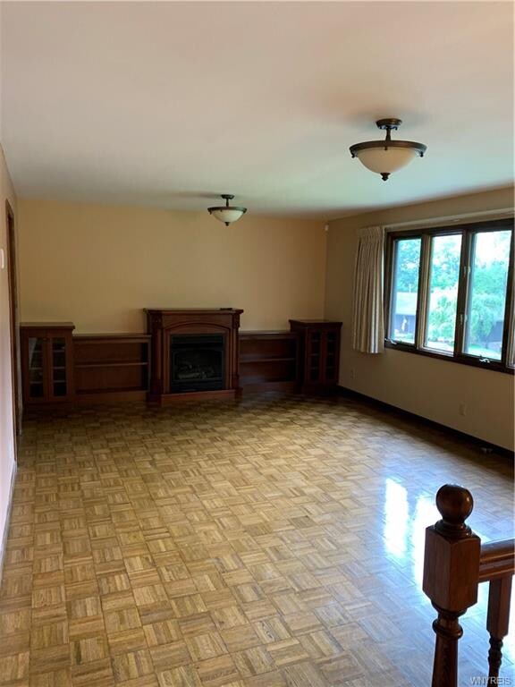 Large Living Room, built in shelving unit and gas 