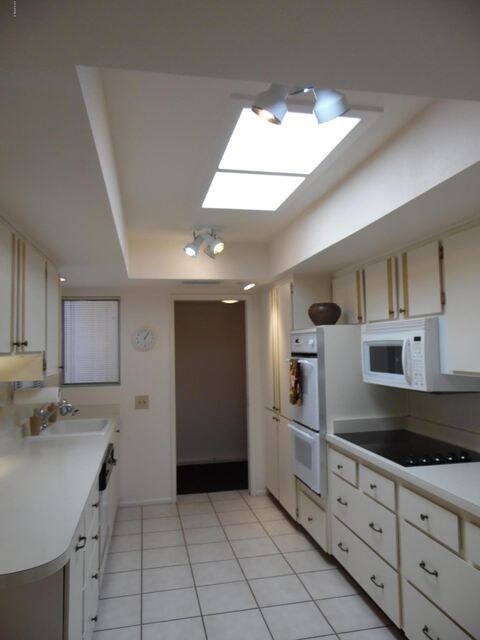 KITCHEN WITH UPGRADED LIGHTING AND SKYLI
