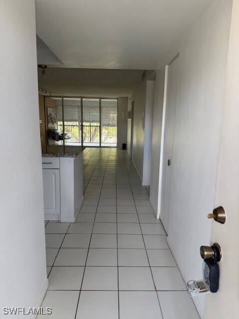 Corridor featuring light tile patterned flooring