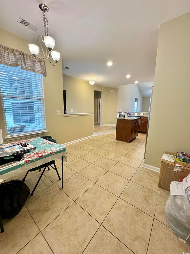 Dining room featuring light tile patterned floorin