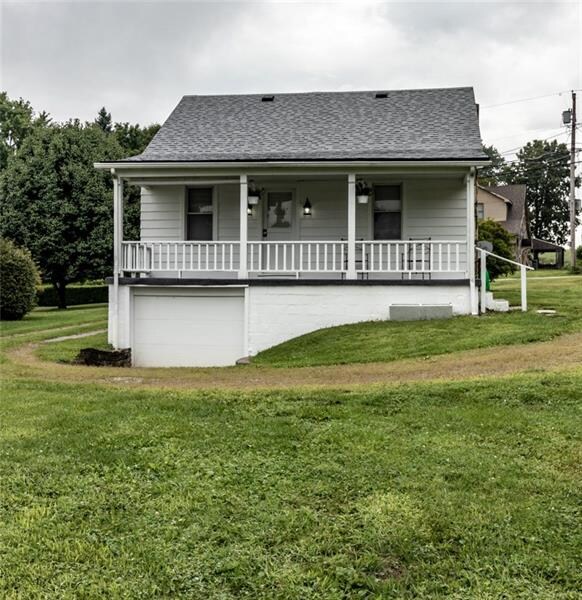 Large Driveway and one car garage with a large bac