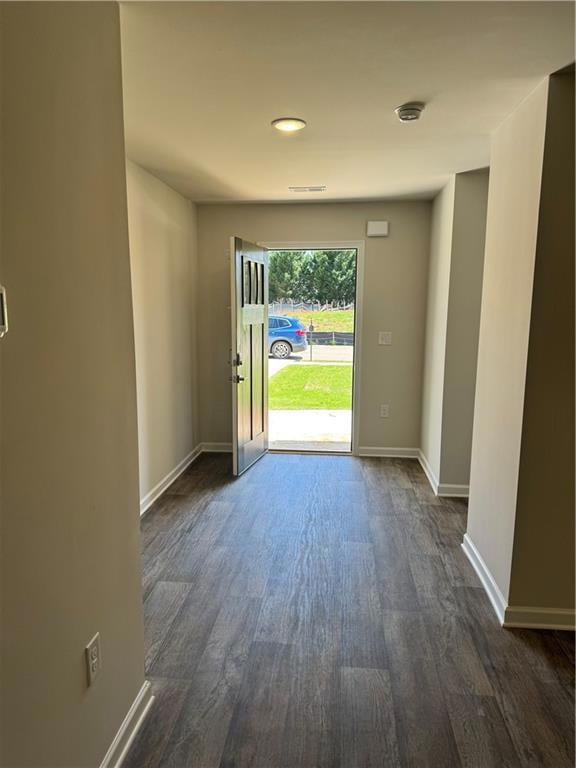 Entryway featuring dark wood-style flooring, visib
