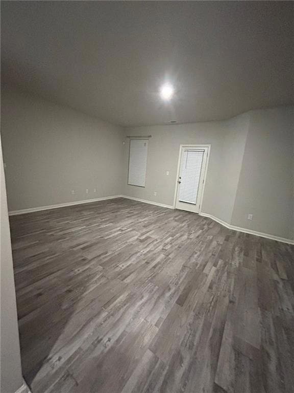 Unfurnished room with dark hardwood / wood-style f