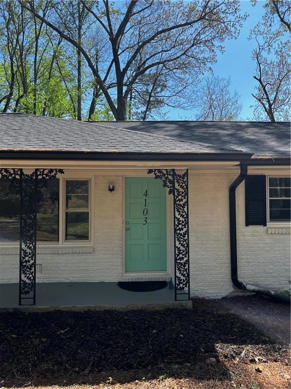 Doorway to property with brick siding