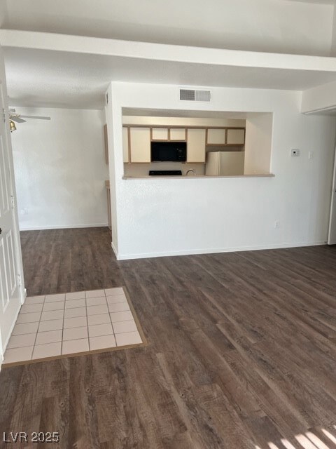 Unfurnished living room featuring visible vents, c
