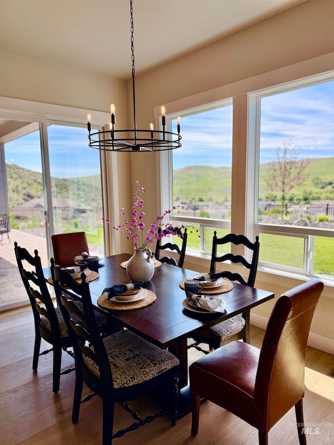 Dining room featuring a mountain view, light wood-type flooring, and a chandelier