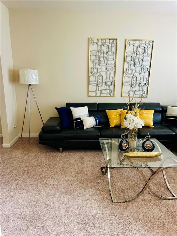 Carpeted living room featuring baseboards