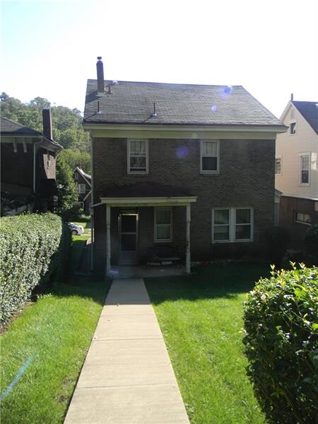 The back of the house features a concrete walkway 