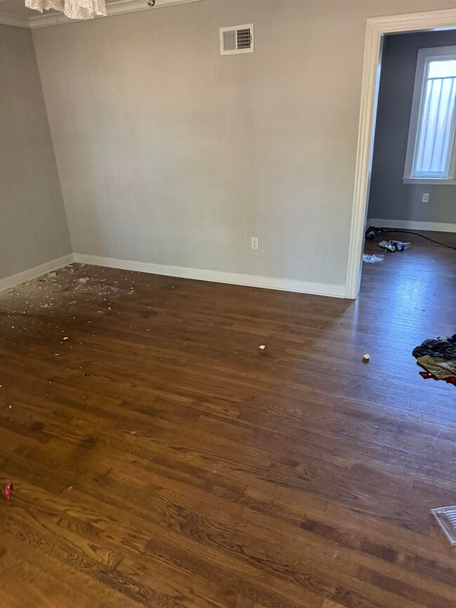 Empty room featuring dark hardwood / wood-style fl