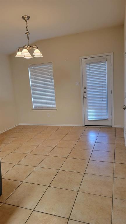 Spare room featuring baseboards, an inviting chan