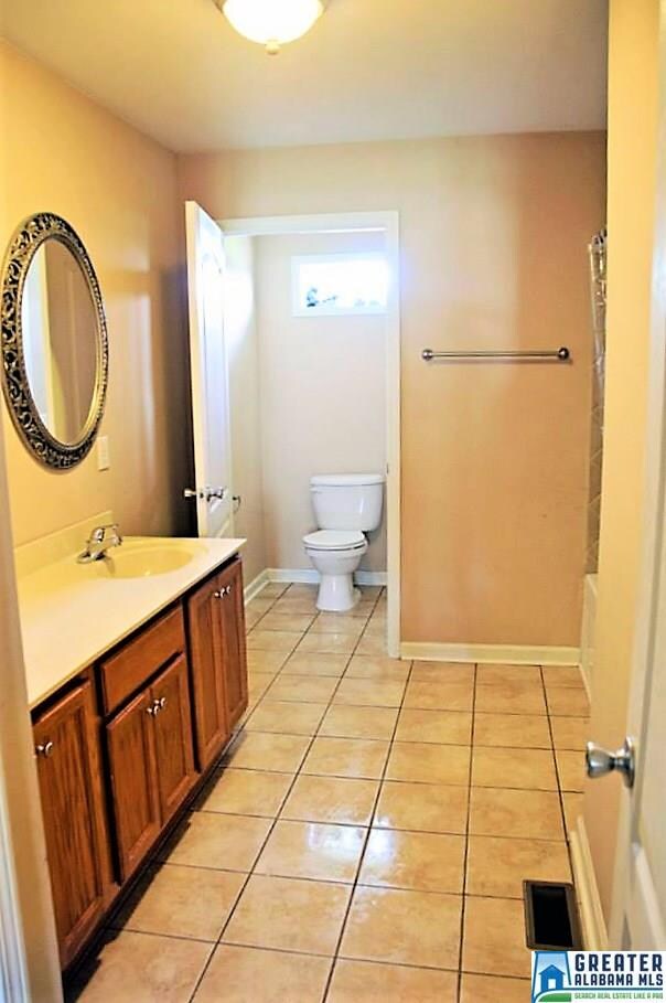 A large master bathroom with a walk in closet.