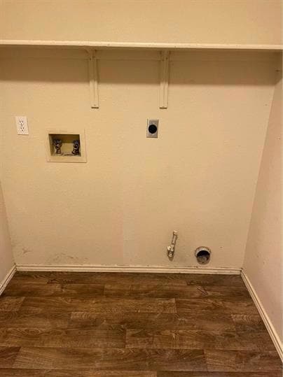 Clothes washing area featuring hookup for an elec