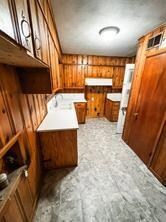Washroom featuring wood walls