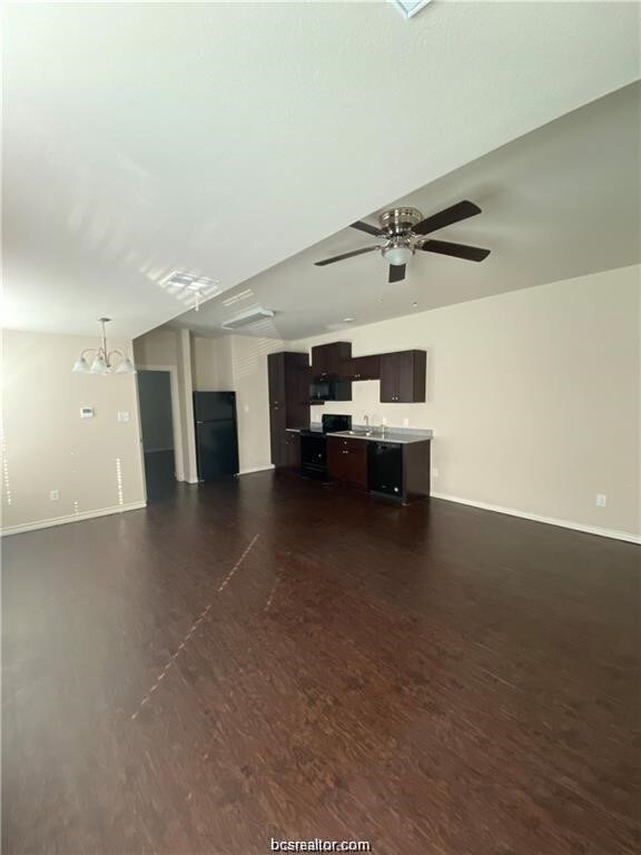 Unfurnished living room with dark wood-style floor