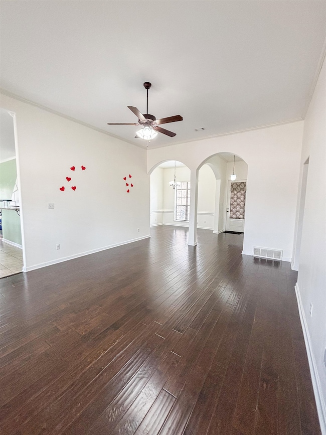 Unfurnished living room featuring baseboards, visi