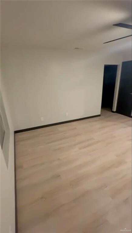 Unfurnished room featuring light wood-style floors and baseboards