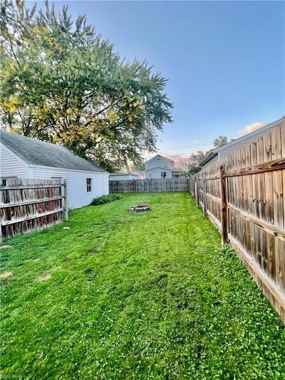 View of yard featuring an outdoor firepit