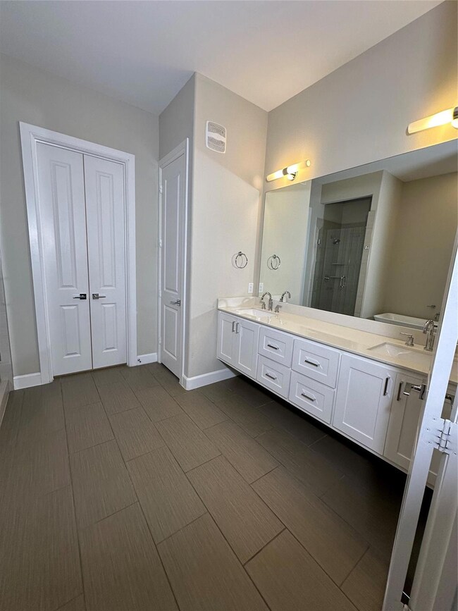 Bathroom with vanity and a shower with shower door