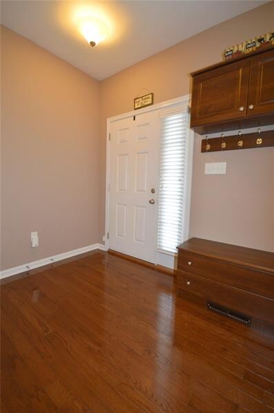 ENTRY AREA WITH CUSTOM COAT HOOKS, SHOE STORAGE AN