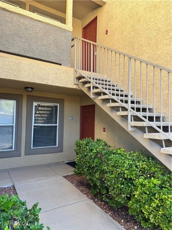 View of exterior entry with stucco siding
