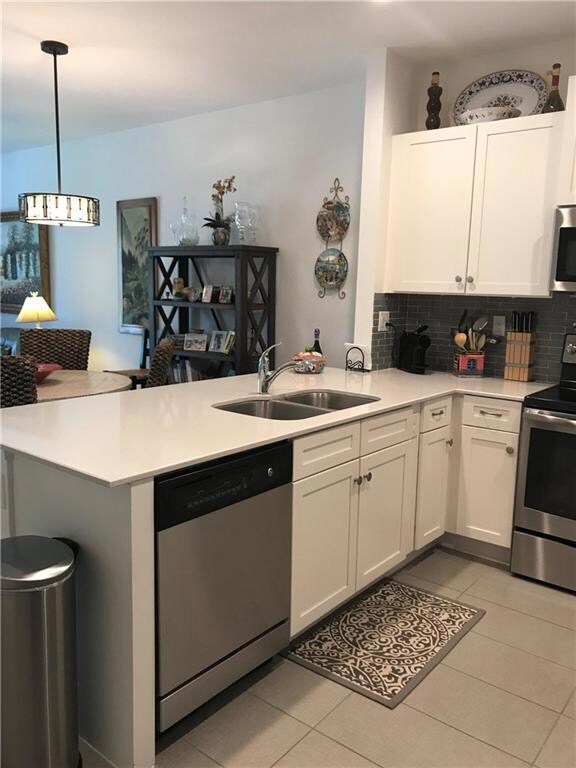 Kitchen with white cabinets and white quartz countertops