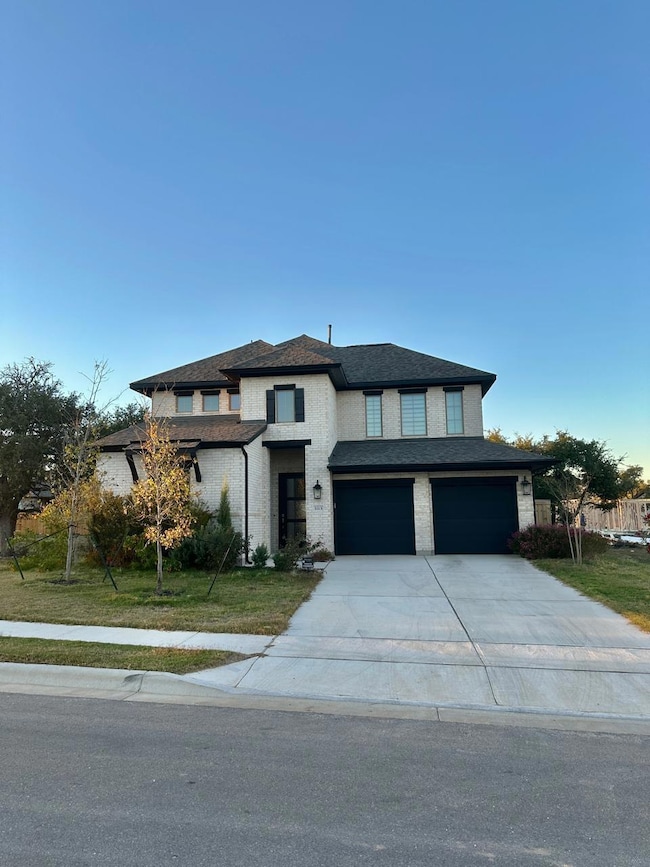Prairie-style house featuring driveway, a garage, and a front yard