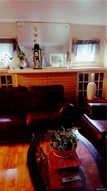 LIVING ROOM WITH FIREPLACE MANTEL AND SIDE CABINET