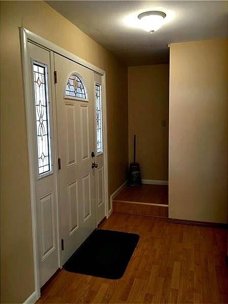 Lovely foyer with leaded glass door and convenient