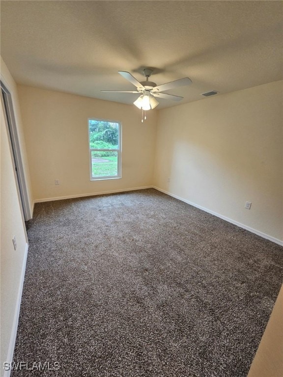 Unfurnished room featuring ceiling fan and carpet