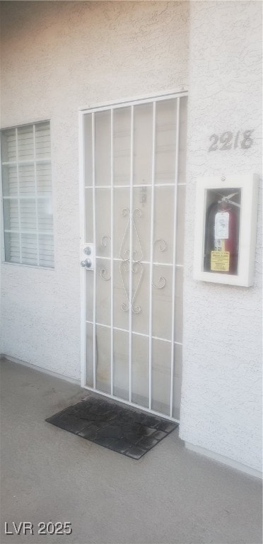 Property entrance with stucco siding