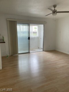 Empty room featuring light wood-type flooring and ceiling fan