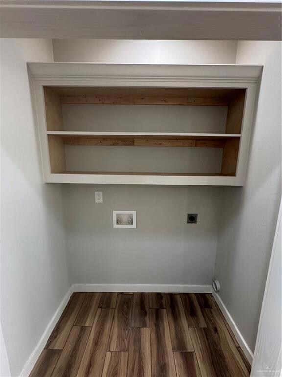 Clothes washing area with hookup for a washing machine, baseboards, laundry area, dark wood finished floors, and electric dryer hookup