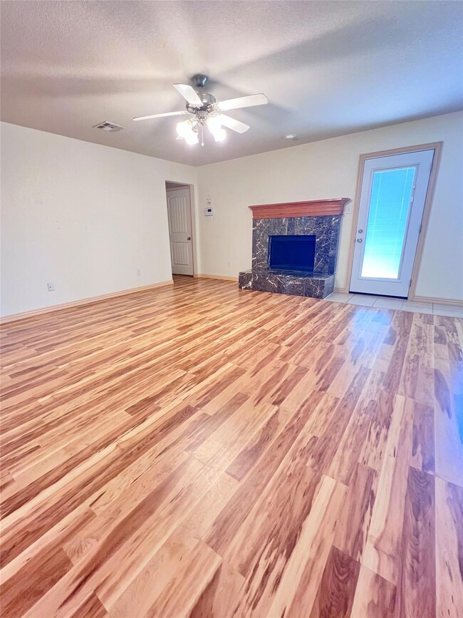 living room featuring a high end fireplace, light 