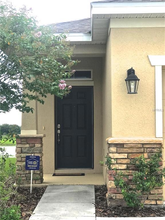 Front Door with stone around the home