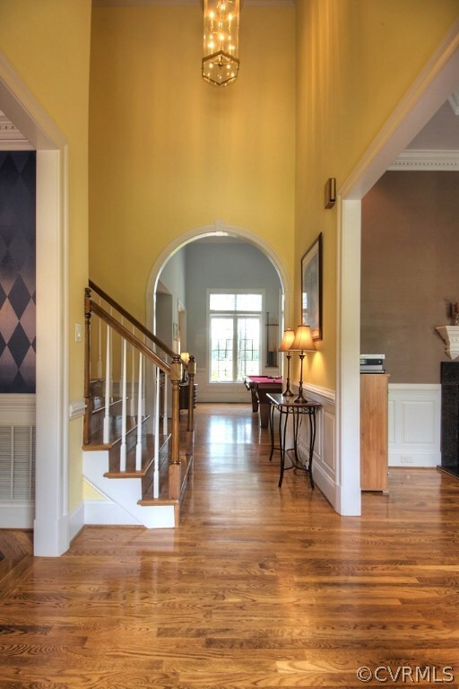 Two story foyer with hardwood floors and moldings