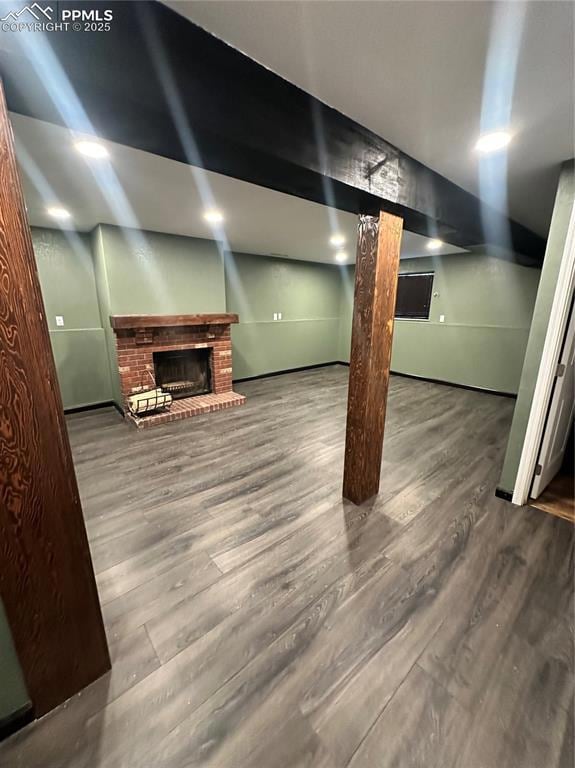 Finished basement featuring a fireplace and wood finished floors