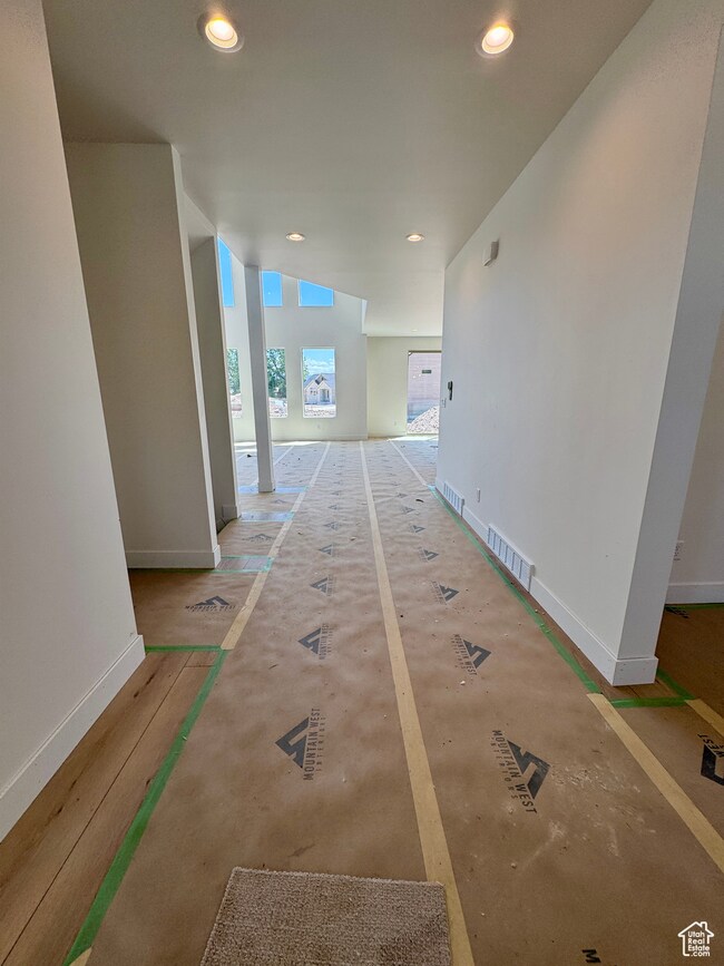 Hall featuring baseboards and recessed lighting