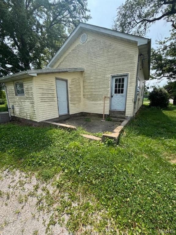 Rear view of house with a yard