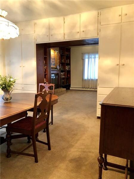 Built-in storage cabinets in the dining room surro
