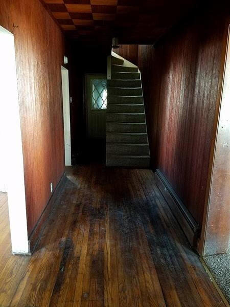 Wide entry with original hardwood floors.