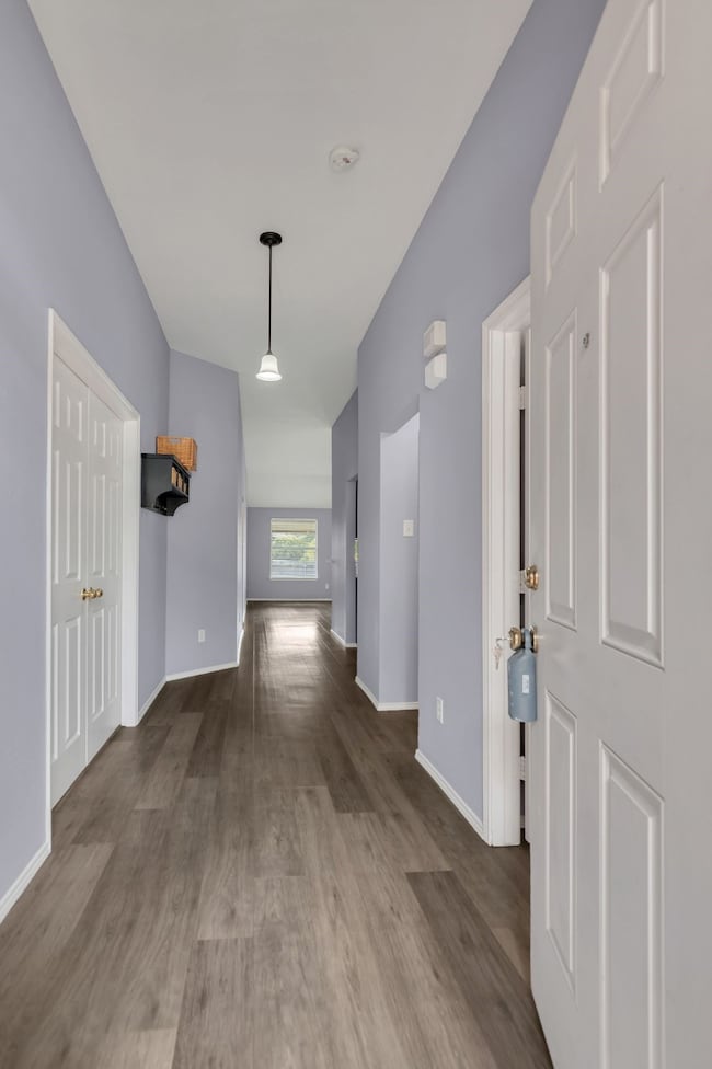 Corridor featuring wood finished floors and baseboards