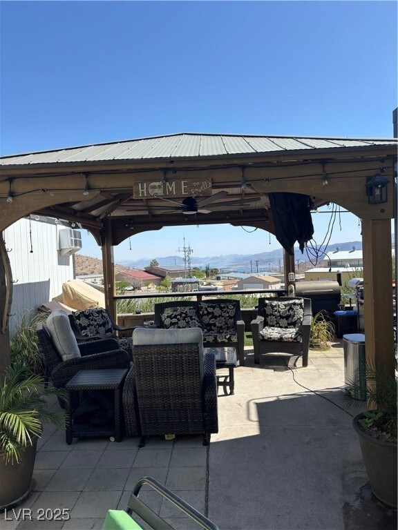 View of patio featuring a gazebo and an outdoor li