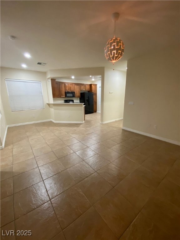 Unfurnished living room with baseboards, recessed