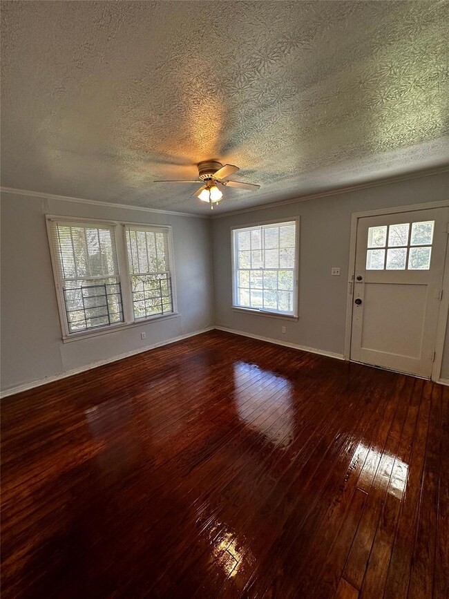 Unfurnished room with crown molding, a textured ce