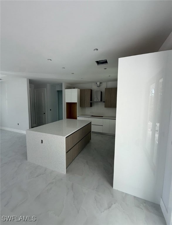 Kitchen with modern cabinets, white cabinetry, lig