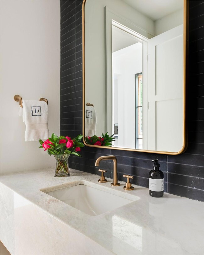 Powder bath with marble countertop & black glass t